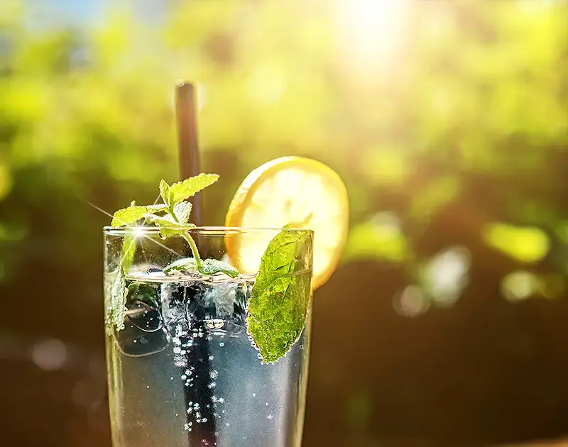 Glass of refreshing fruit juice in the sun