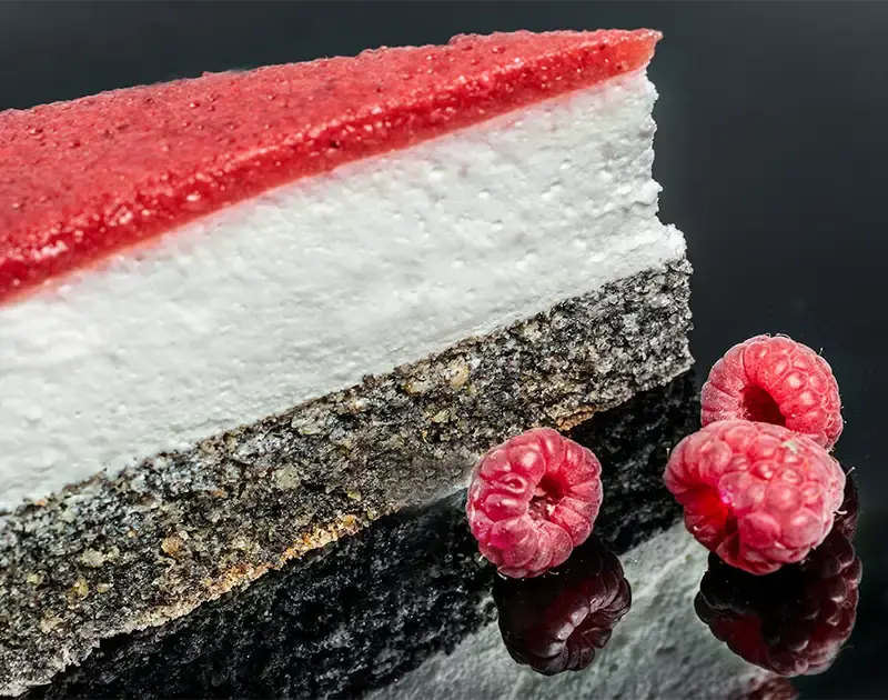 Raspberry poppy seed cake on a black plate