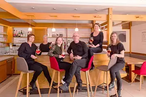 Team Cafe Brückenwirt sits in front of the bar at Cafe Brückenwirt